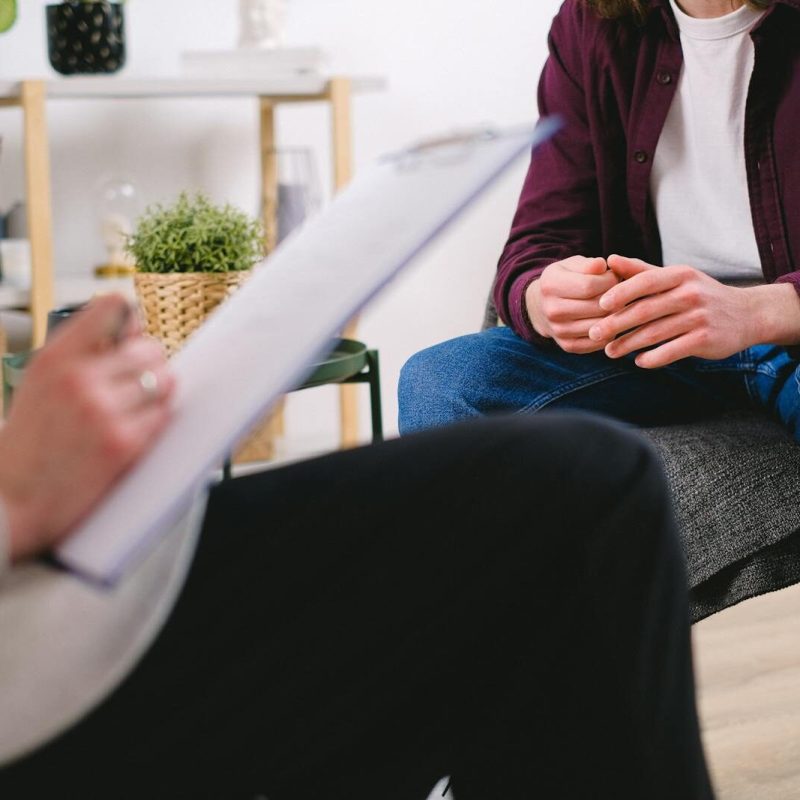 Therapist and client discussing issues in a psychotherapy session, highlighting mental health support.